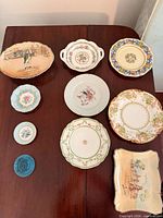 All nine porcelain/ceramic pieces laid out on table