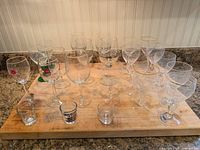 Top view of entire set showing wine glasses, goblets and shot glasses arranged on board