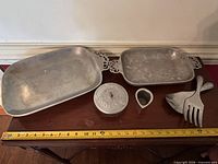 All five pewter pieces arranged with measuring tape