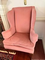 Front view of pink wingback chair
