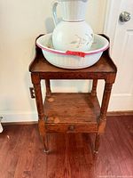 Pitcher and wash basin on wooden stand