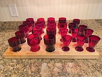 All 24 ruby red glasses arranged on board