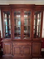 Front view of full china cabinet showing glass doors and lower storage