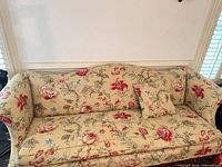 Full front view of sofa, showing upholstery pattern, shape and pillow