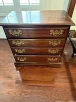 Front view of 4-drawer dresser showing brass pulls and overall finish