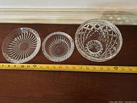 All three clear cut glass pieces with tape measure for scale