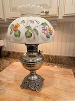 Full view of oil lamp with shade and base