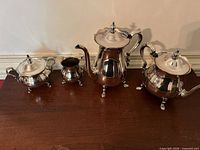 All four silver plated pieces displayed together