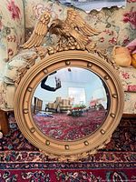 Front view showing entire gilded convex mirror with eagle crest