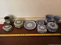 Group shot of all Wedgwood pieces lined up with ruler for scale