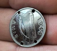 Obverse showing harp, date 1944, four drilled holes