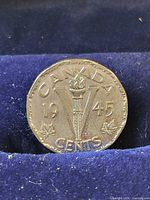 Reverse of 1945 Canada 5-cent coin in case