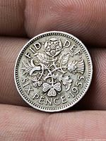 Reverse showing FID DEF SIX PENCE 1955 with floral emblems