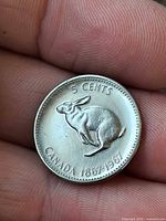 Reverse of 1967 Canada 5 cent coin showing rabbit design and dates