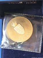 Obverse showing coat of arms and CANADA legend in plastic sleeve