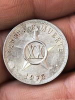Obverse of 1972 Cuban 20 Centavos coin showing star, XX, PATRIA O MUERTE legend and date