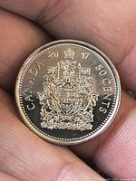 Reverse of 2017 Canadian 50 cent coin showing Coat of Arms