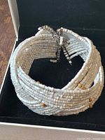 Bracelet closed in box showing twisted seed bead design
