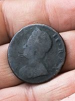 Obverse side showing worn bust profile
