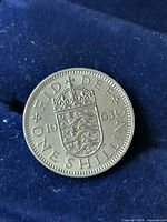 Reverse side of 1963 UK one shilling coin with crowned arms