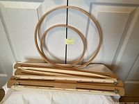 Two wooden hoops and disassembled scroll frame laid out