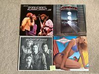 Front covers of all four albums laid out 2×2