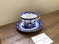 Cup and saucer side view on wooden surface