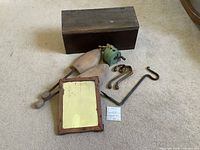 Group shot of all items: wooden mailbox, mirror, shoe shapers, brass hooks, clothesline reel, wrought iron hook