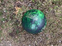 Top view of green Brunswick TZone bowling ball showing logo and color pattern