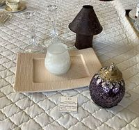 Overview of tray, candle holders, frosted candle, lantern, purple light