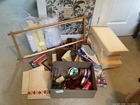 Group shot of entire lot on floor: stretcher frame, foam blocks, box of ribbons, fabric pieces