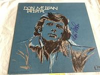 Front cover showing artwork and autograph