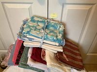 Stack of assorted fabrics showing variety of colors and patterns