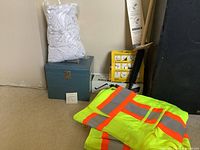 Lot overview with rag bag, closed blue steel box, vests, brush and floor kit packaging