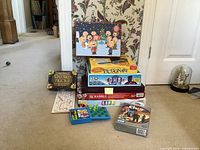Stacked board games with Peanuts puzzle on top and surrounding items