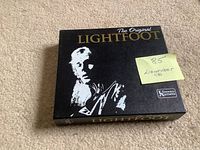 Front of black slipcase with title and artwork