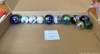 Marbles lined in box showing variety and size