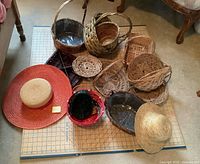 Overview of all wicker baskets, trays and two hats on cutting mat