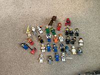 All Lego minifigures, horse and accessories laid out on carpet