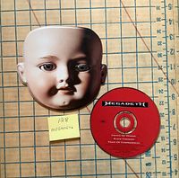 Front view showing CD label and doll face cover