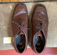 Top view of both brown Nunn Bush shoes showing laces, leather uppers and interior branding