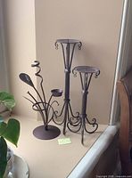 All three metal candle holders on windowsill