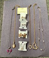 Full lot overview showing all five necklaces and earring cards