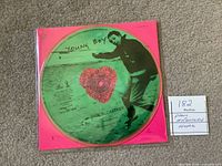 Front view of picture disc in sleeve showing artwork and title