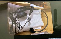 Boxed GN wired headset showing mono earpiece, boom mic, quick-disconnect lead and packaging