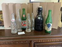 All seven bottles lined up on surface