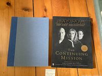 Front view of both books laid flat showing covers