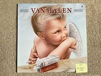 Front album cover with cherub artwork and band name