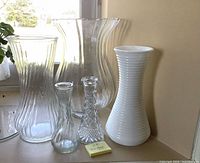 Group of five vases showing size variation and materials