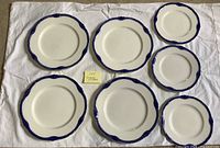 Top view of all seven plates showing sizes and blue border pattern